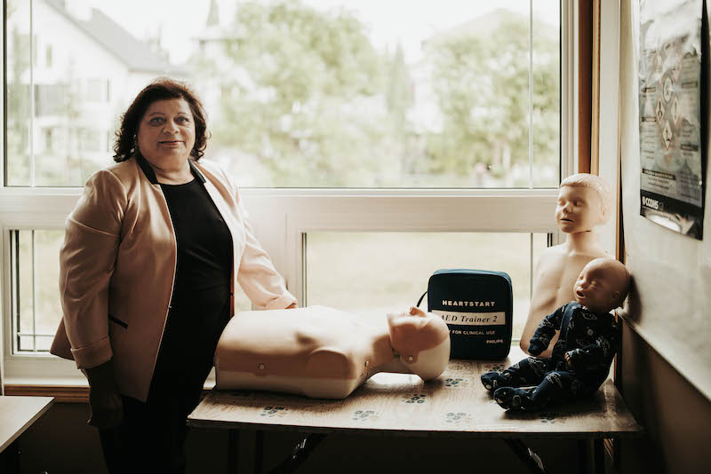 certified first aid instructor with training manikin